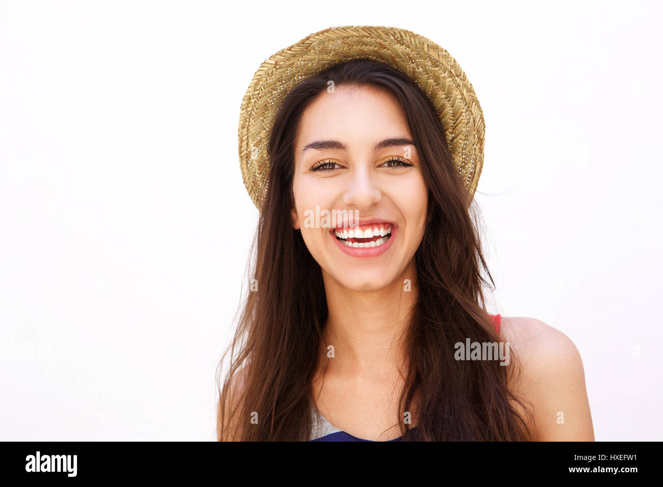 Close up portrait of a smiling cute girl with long hair and hat posing ...