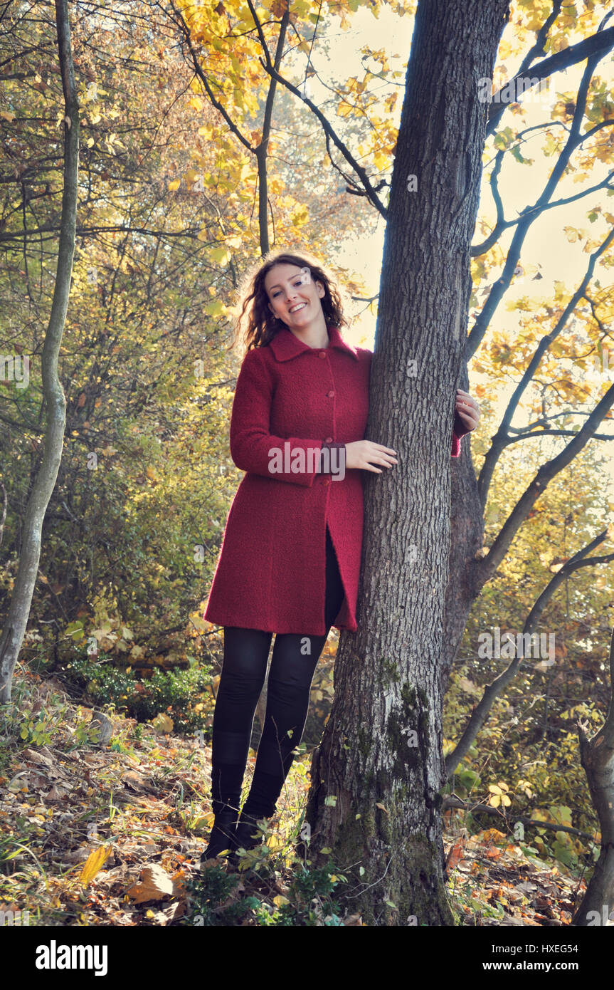 Smiling young woman in forest Stock Photo