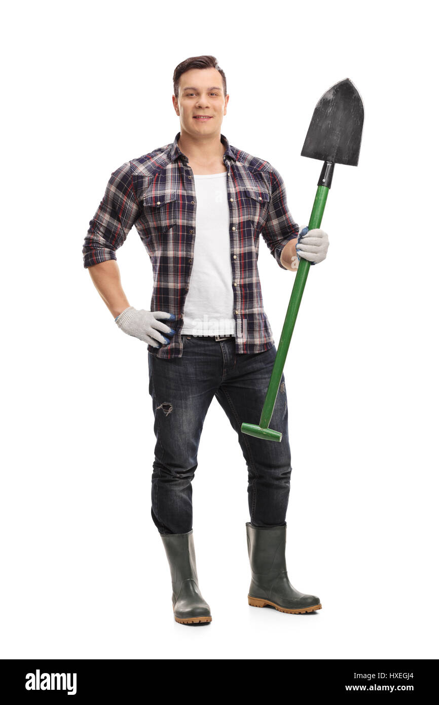 Full length portrait of a gardener with a shovel isolated on white ...