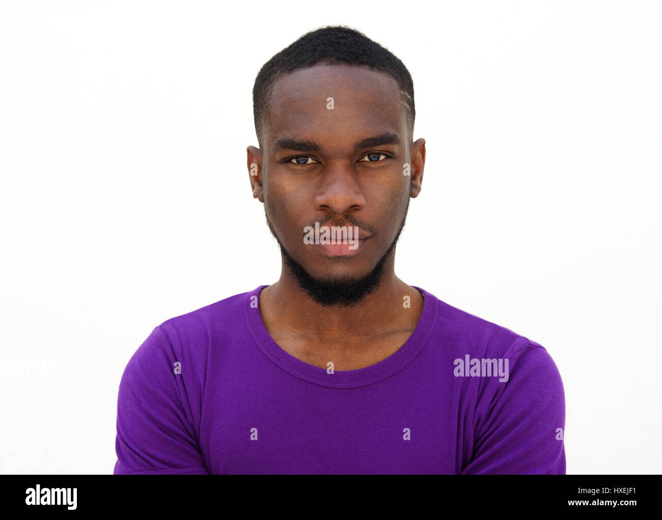 Close up portrait of a serious young african man against white ...