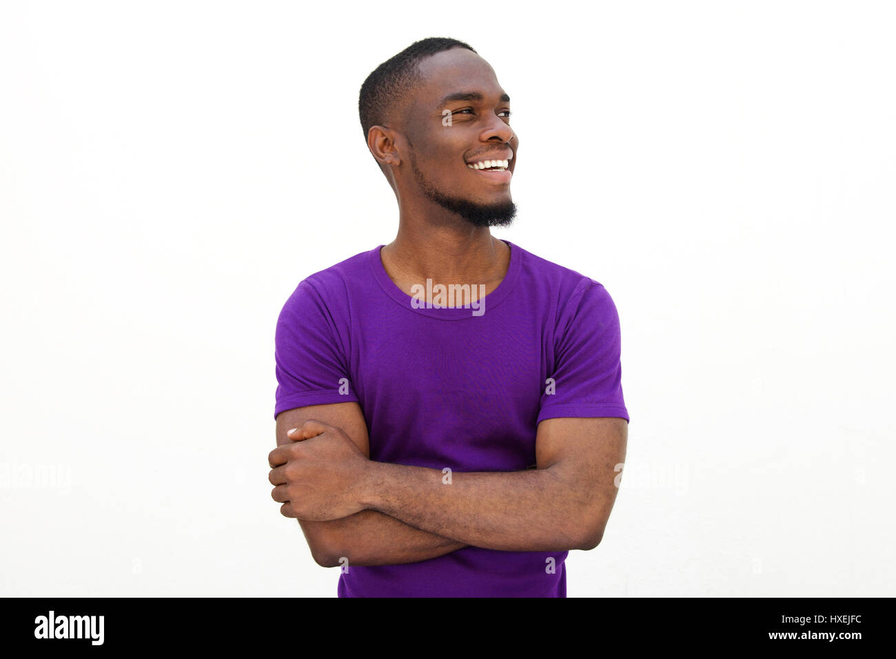 Portrait of a happy african american man smiling with arms crossed ...