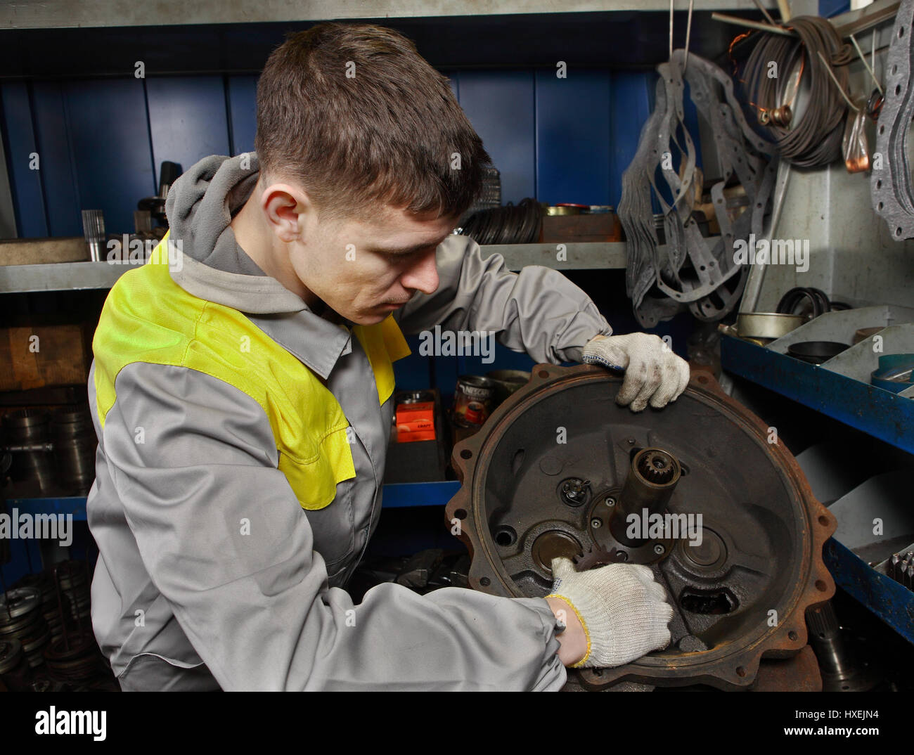 St. Petersburg, Russia - 22 December 2011: Repair shop forklifts, car mechanician assembles truck engine. Stock Photo