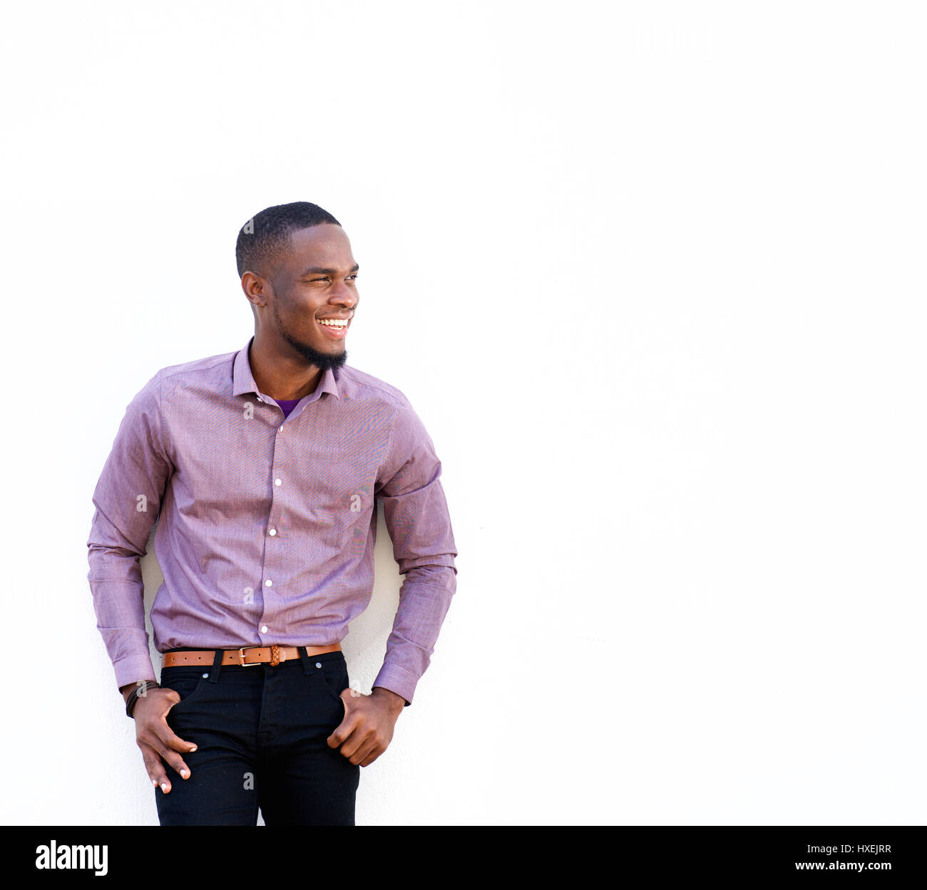 Portrait of confident young african man standing with his hands in ...