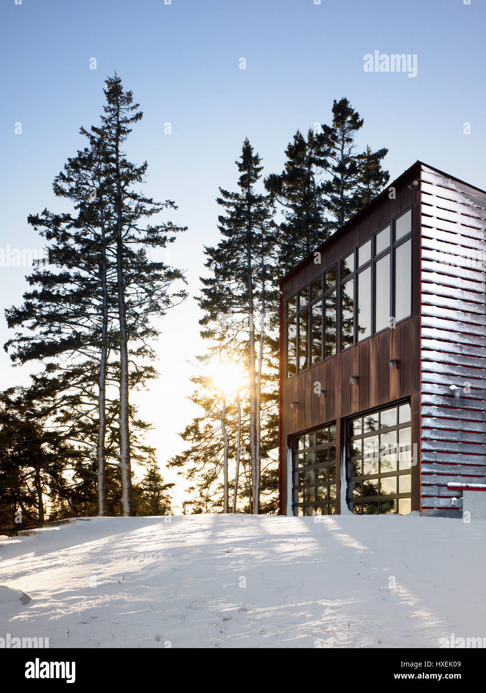 Facade facing the sea in late afternoon sunlight. Island House, North