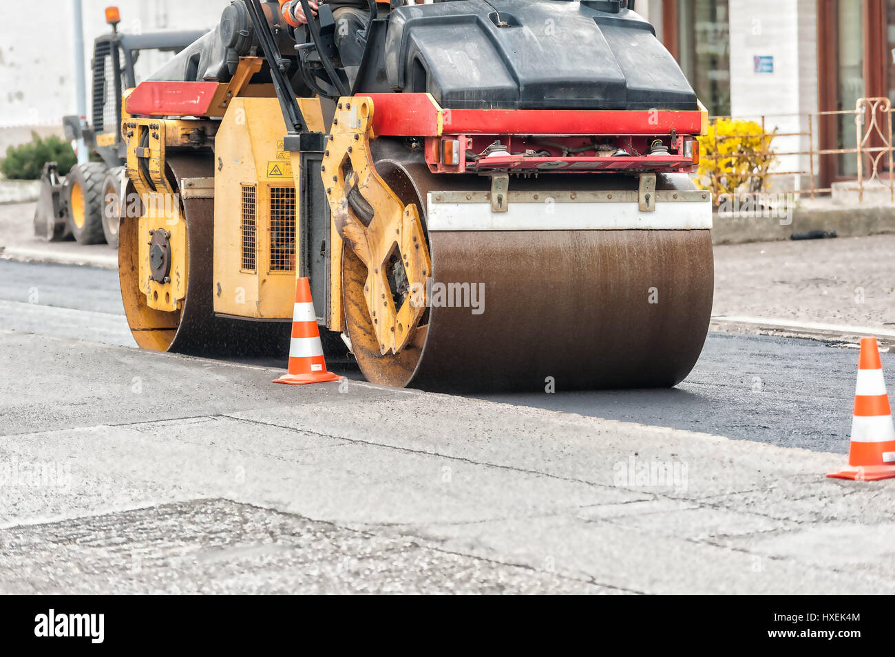 Road under construction. Road roller in action. Stock Photo
