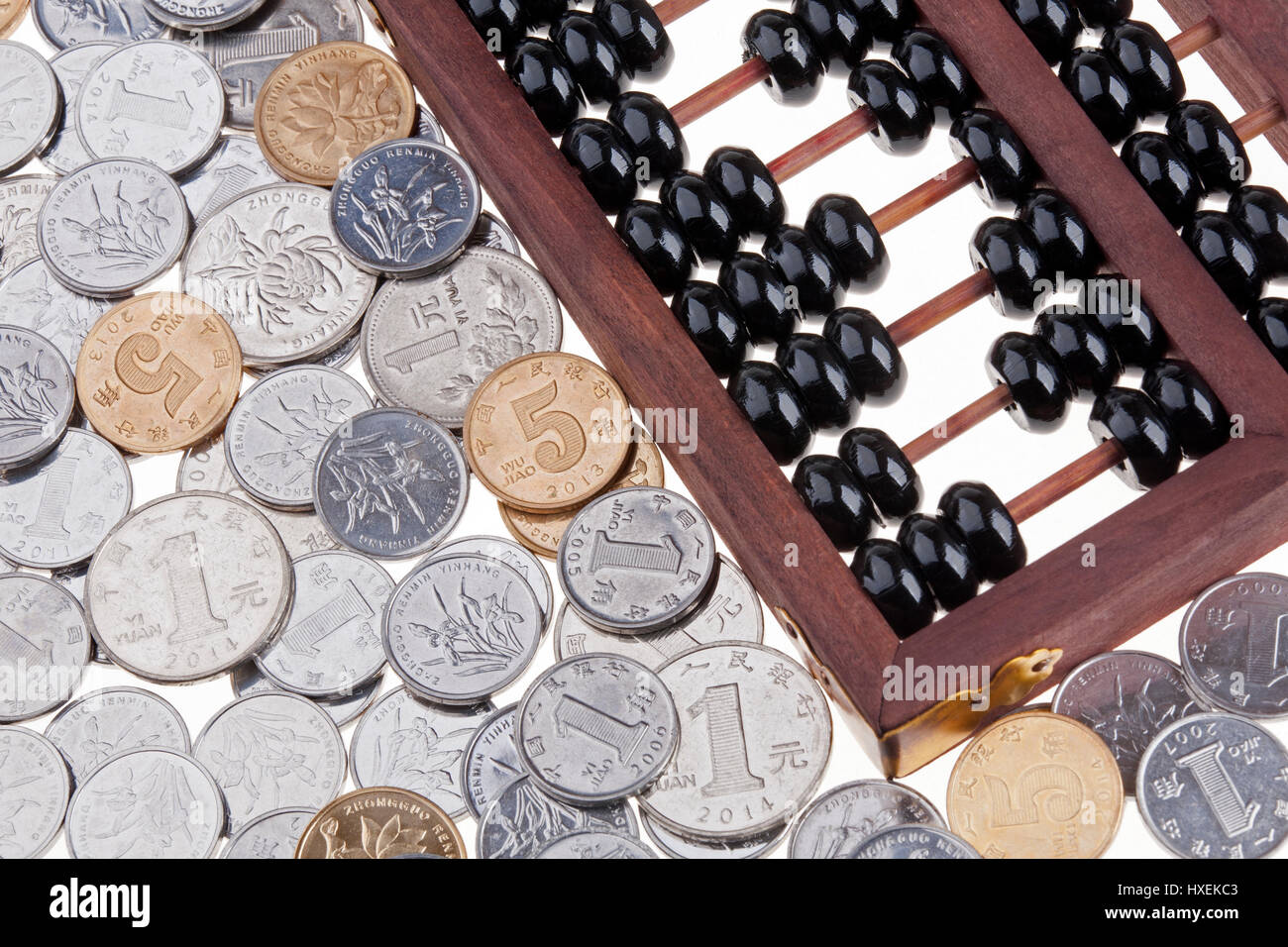 Close up of an old wooden Chinese Abacus and Chinese coins Stock Photo