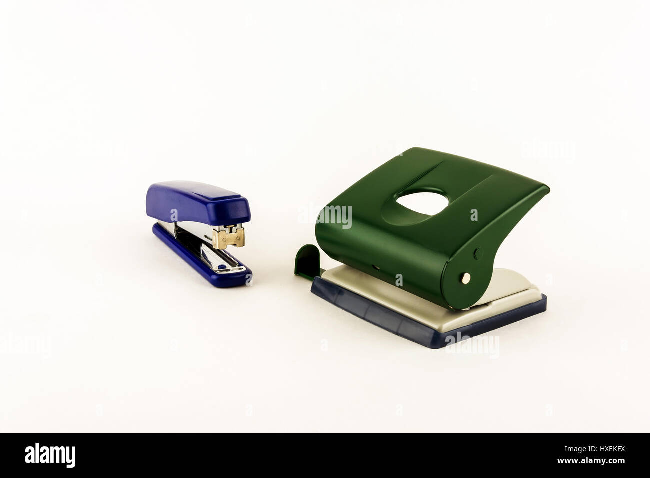 Stationery stapler and punch on a light background Stock Photo Alamy