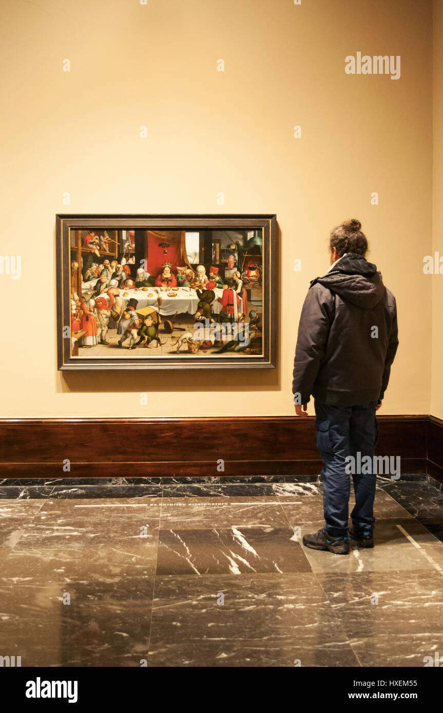 Bilbao, Spain: looking at Burlesque Feast by Jan Mandijn at Bilbao Fine Arts Museum, the second most visited museum in the Basque Country Stock Photo