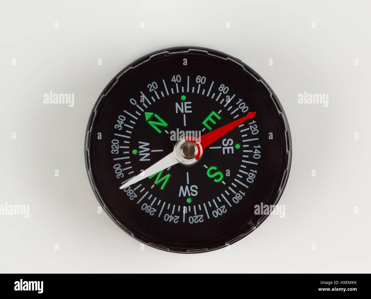 round magnetic compass with bright symbols lies on the table Stock Photo
