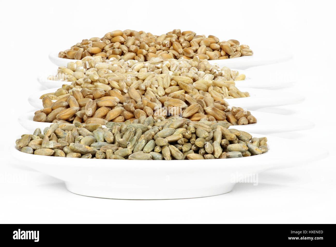 assortment of different cereals in ceramic bowls isolated on white background Stock Photo