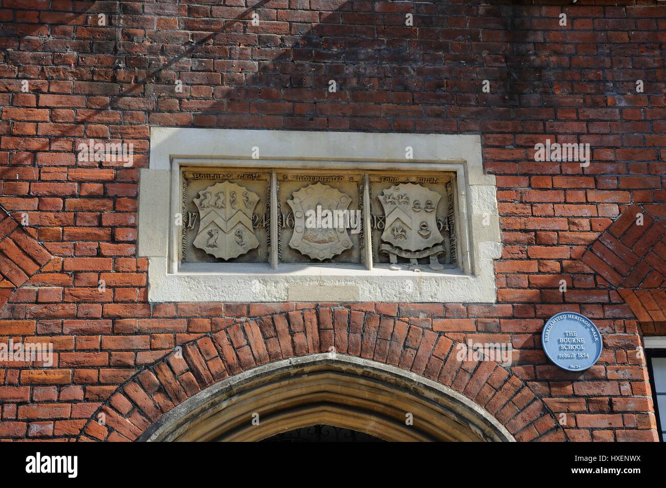 The Bourne School, High Street, Berkhamsted, Hertfordshire, has three coats of arms above the doorway. Stock Photo
