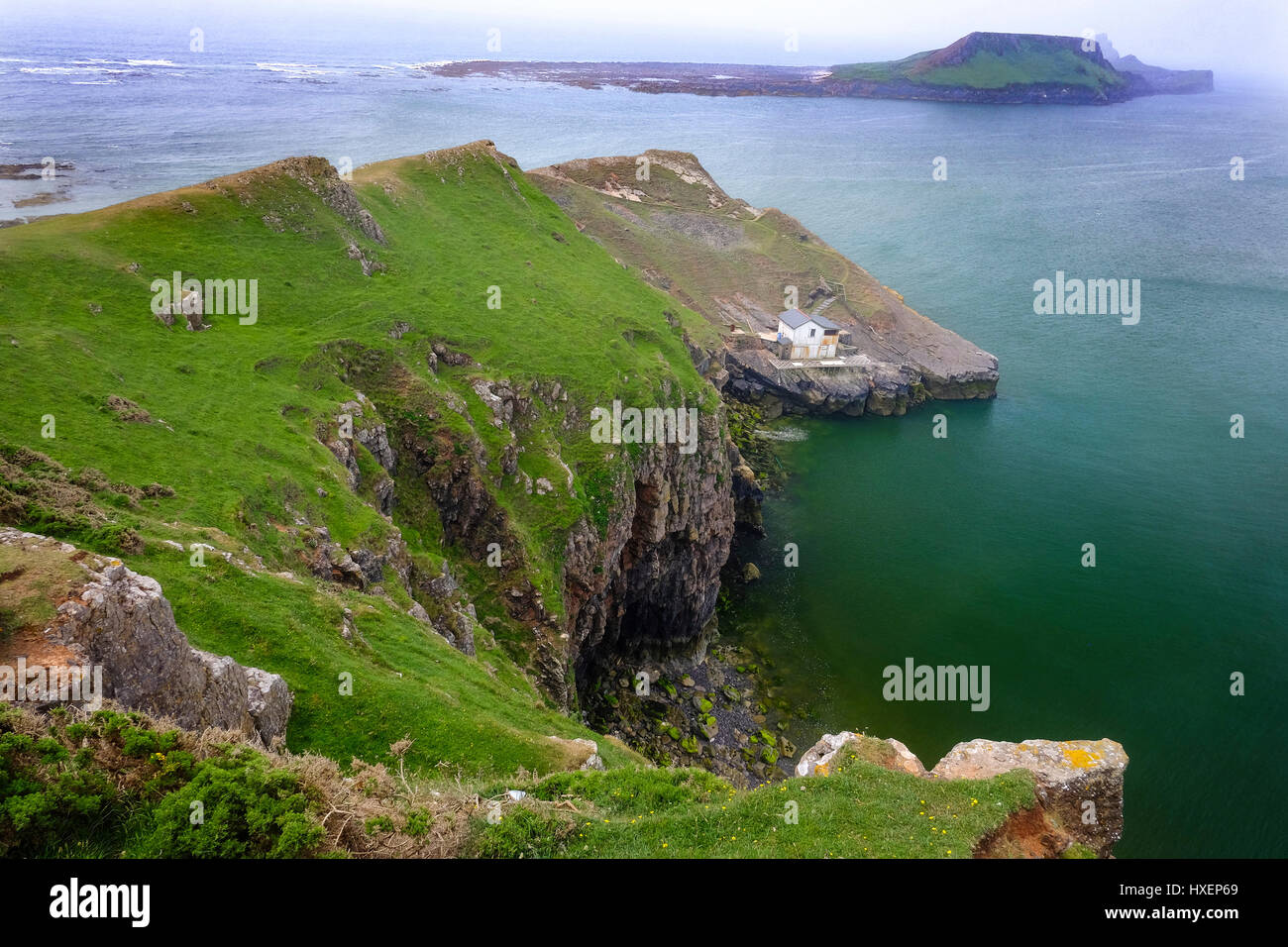 Worm's Head (tidal island) viewed from Rhossili Bay, Gower Peninsula, South Wales (UK). Worm's Head consists of two islands, Inner and Outer Head. Stock Photo