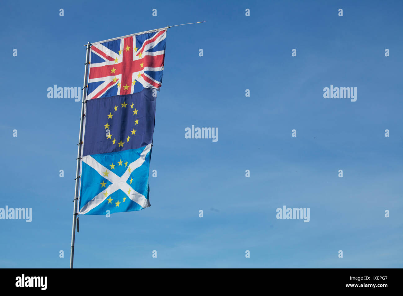 Union Jack, EU Flag and Saltire (Scottish Flag) on a single flagpole Stock Photo
