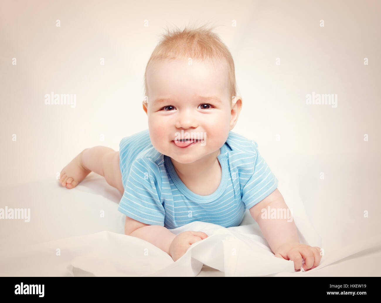 Eight month old baby lying in the bed on white sheet Stock Photo Alamy