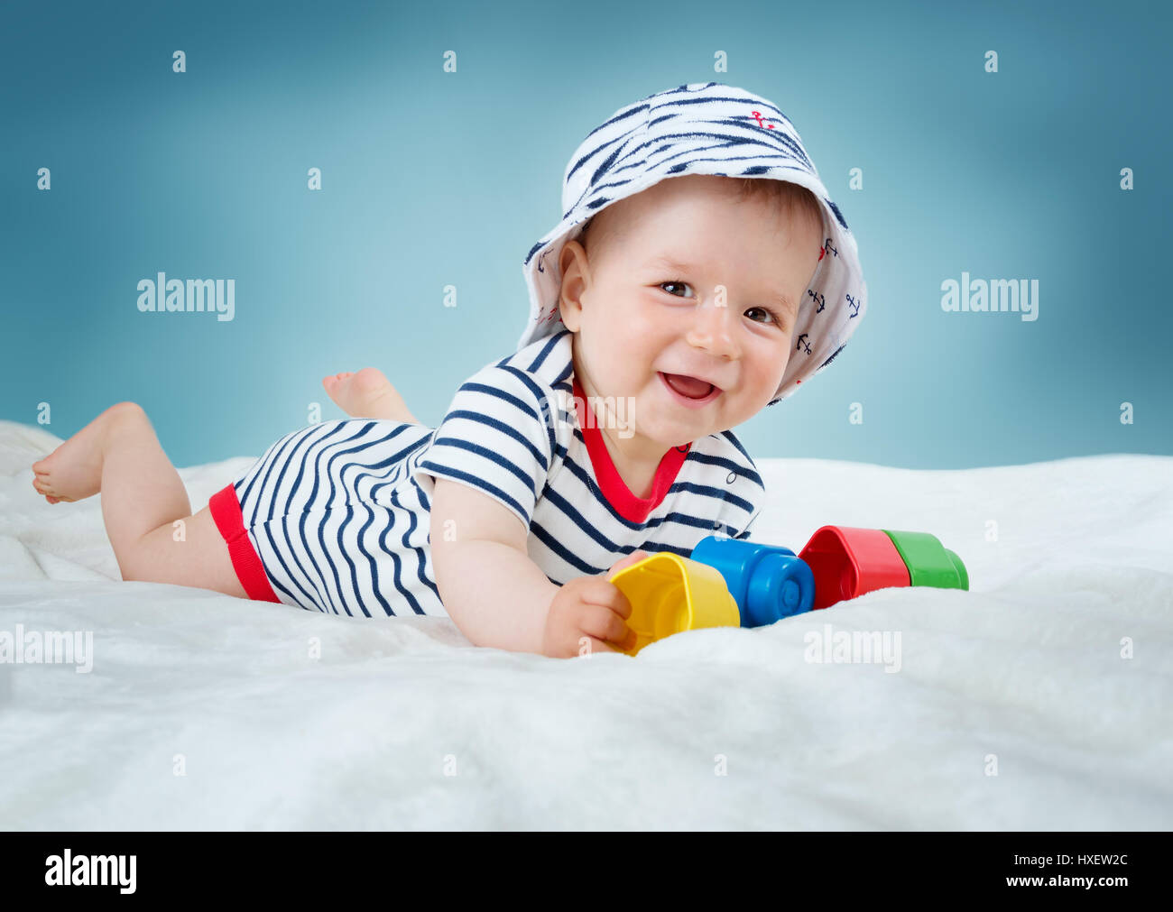 Nine month old baby lying in the bed on white blanket Stock Photo Alamy