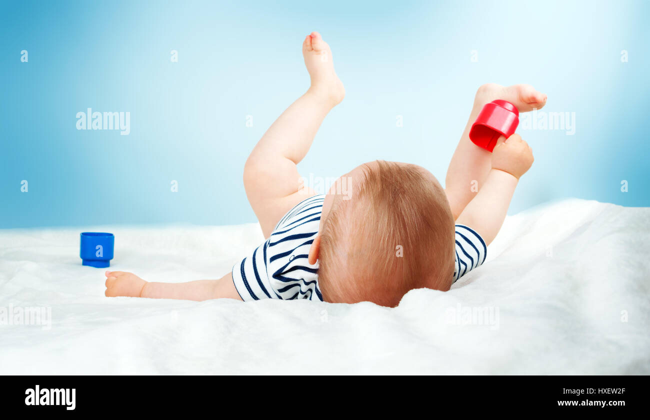 Nine month old baby lying in the bed on white blanket Stock Photo Alamy