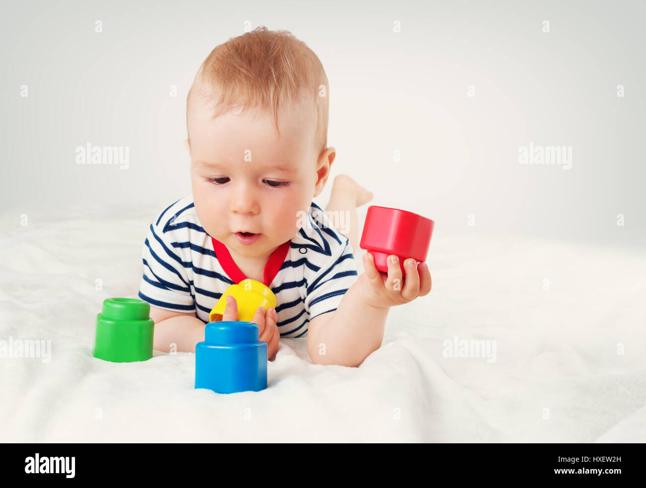 Nine month old baby lying in the bed on white blanket Stock Photo Alamy