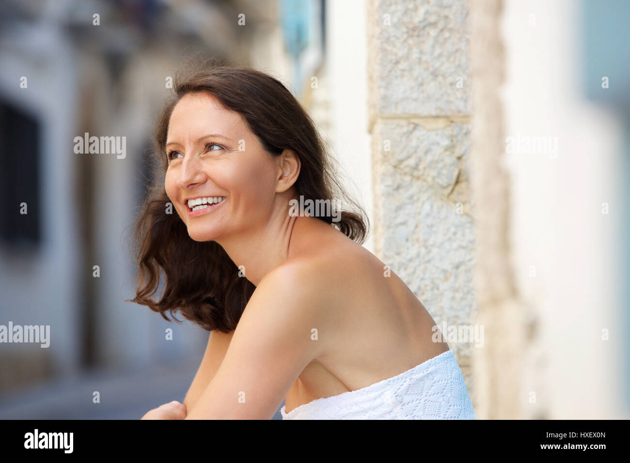 Close up portrait of a smiling older woman sitting outside Stock Photo ...