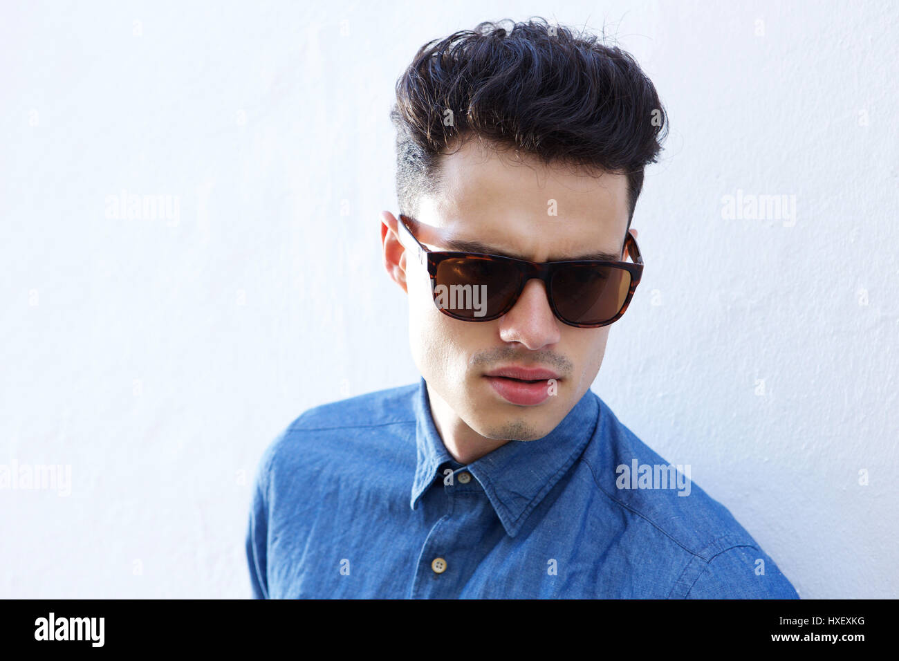 Close up portrait of a handsome male fashion model with sunglasses