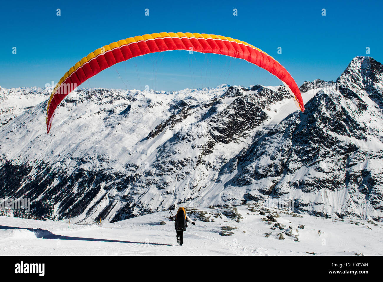 Paraglider taking off, Corvatsch Glacier in winter, Bernina range at