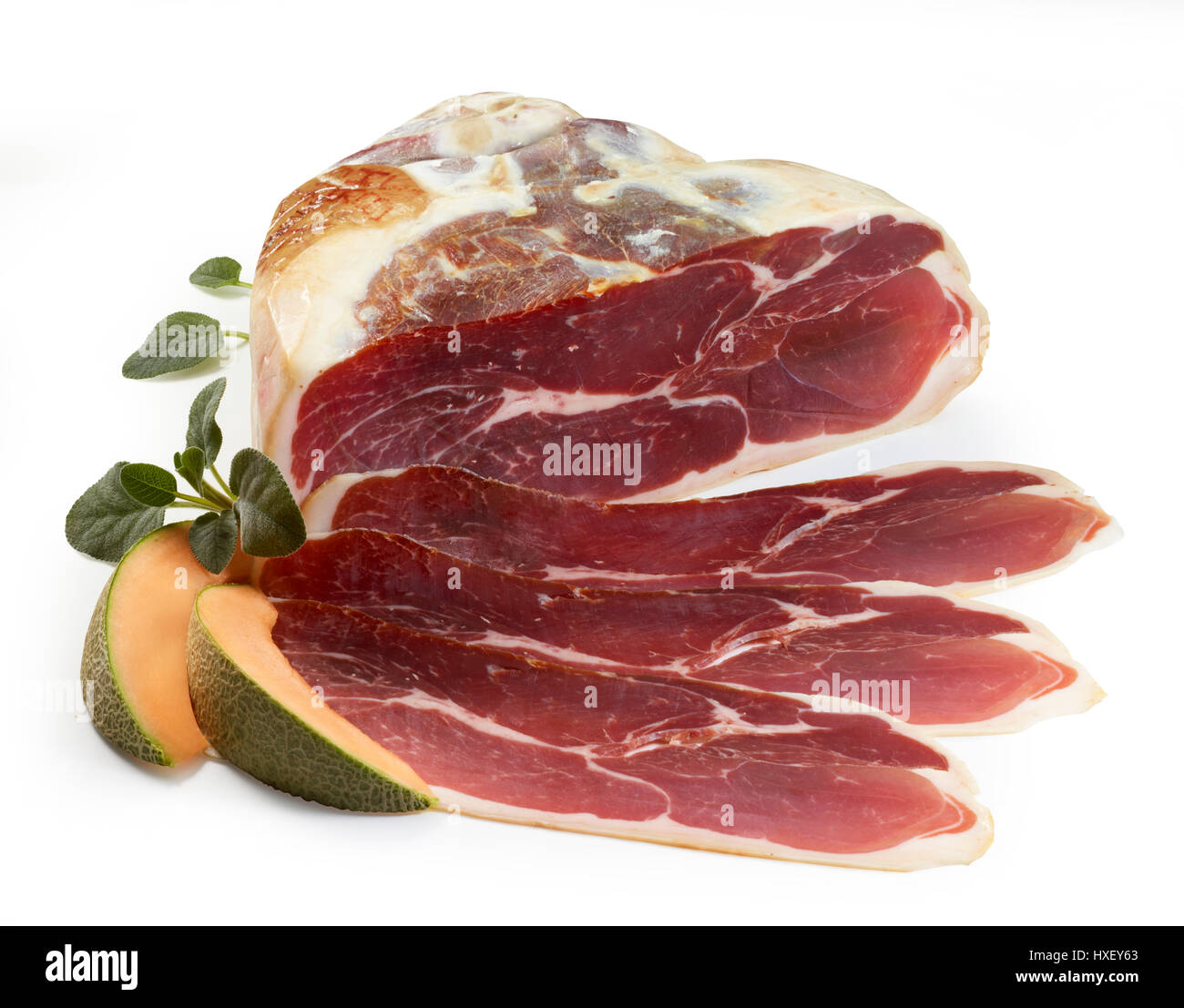 Parma ham with sage (Salvia) and honeydew melon as decoration Stock Photo