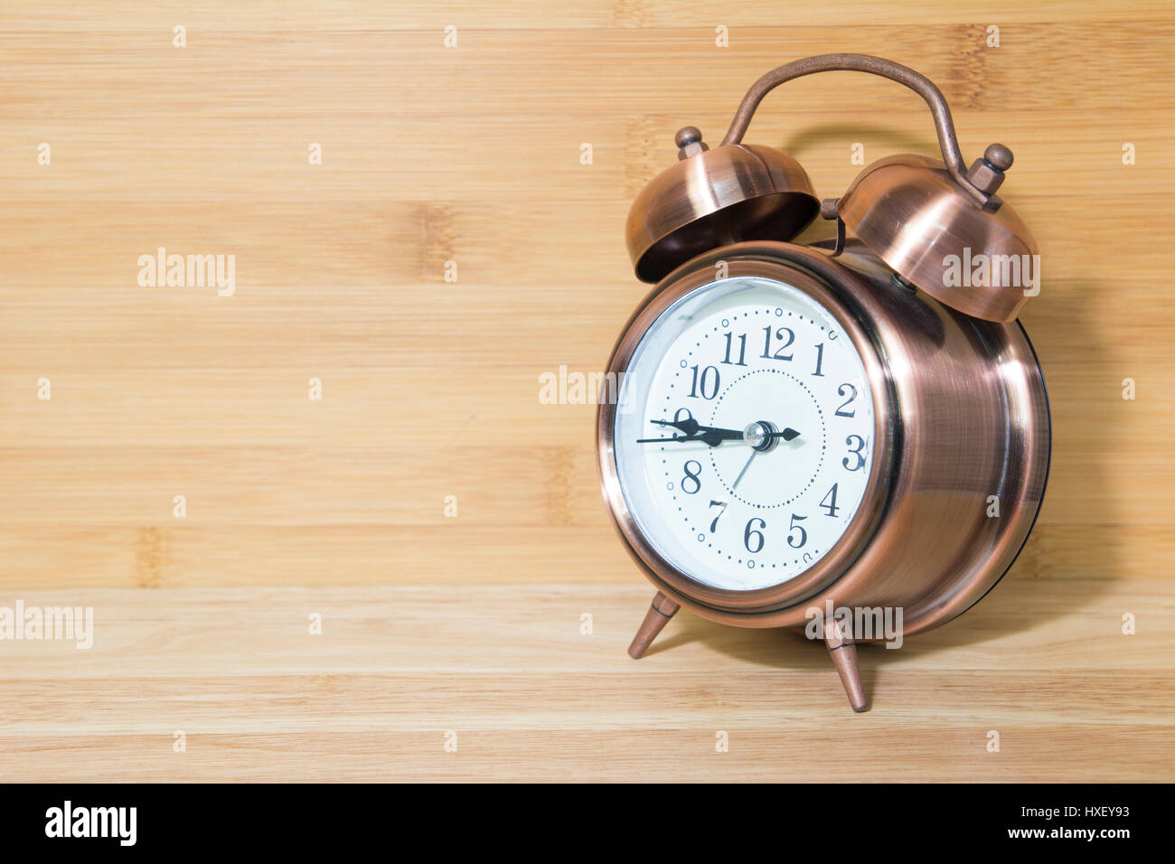 Closeup for retro alarm clock on wooden table Stock Photo - Alamy