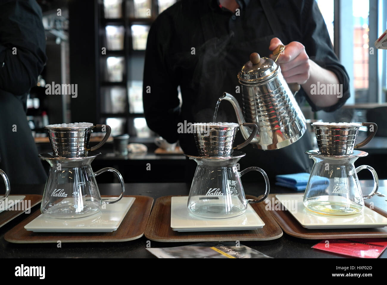 https://c8.alamy.com/comp/HXF02D/a-barista-is-using-a-kalita-wave-dripper-to-brew-coffee-at-the-solberg-HXF02D.jpg