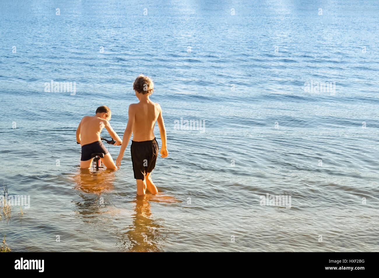 Two boys playing in river hi-res stock photography and images - Alamy
