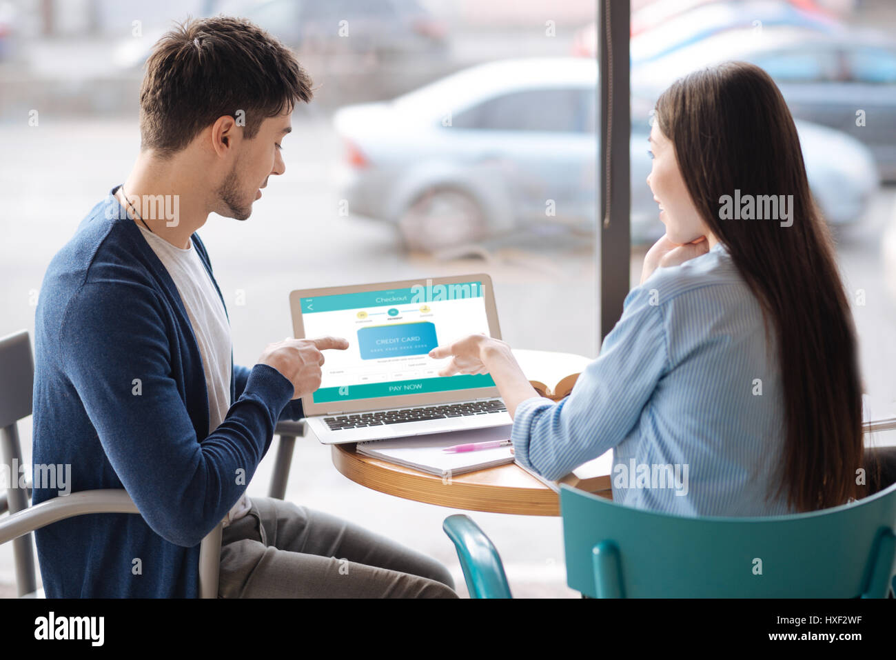 Young guy presenting information from laptop Stock Photo