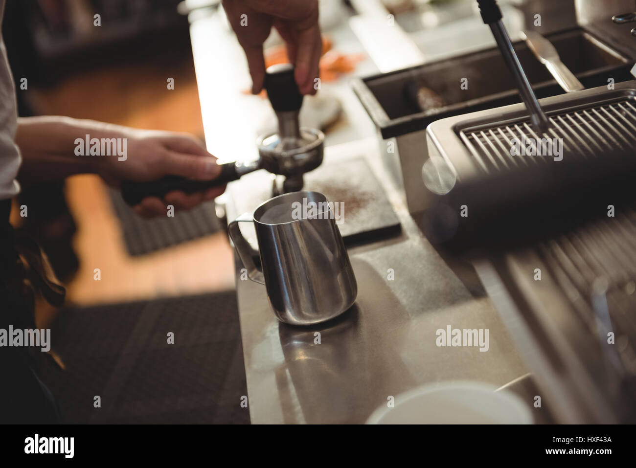 Cropped image of male barista tamping coffee in cafe Stock Photo Alamy