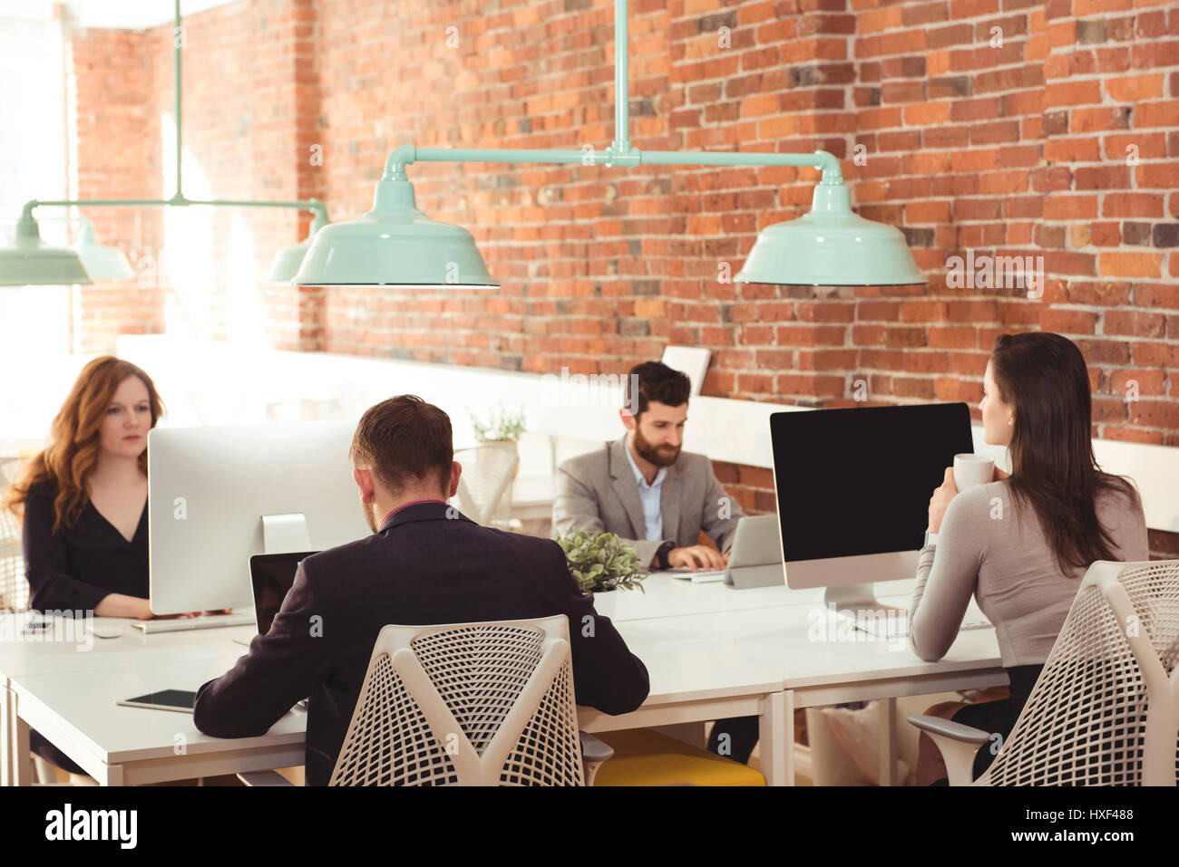 Group executives sitting working together hi-res stock photography and ...