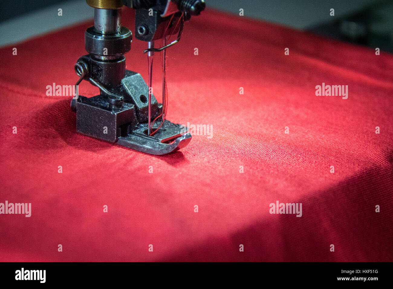 Professional overlock sewing machine with red fabric Stock Photo Alamy