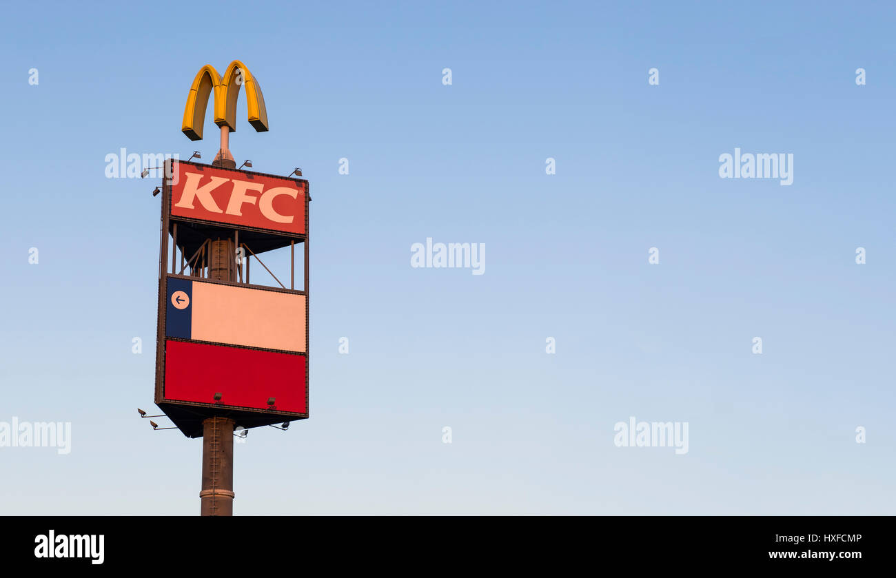 Roadsign post up in the air with McDonalds and KFC logos Stock Photo