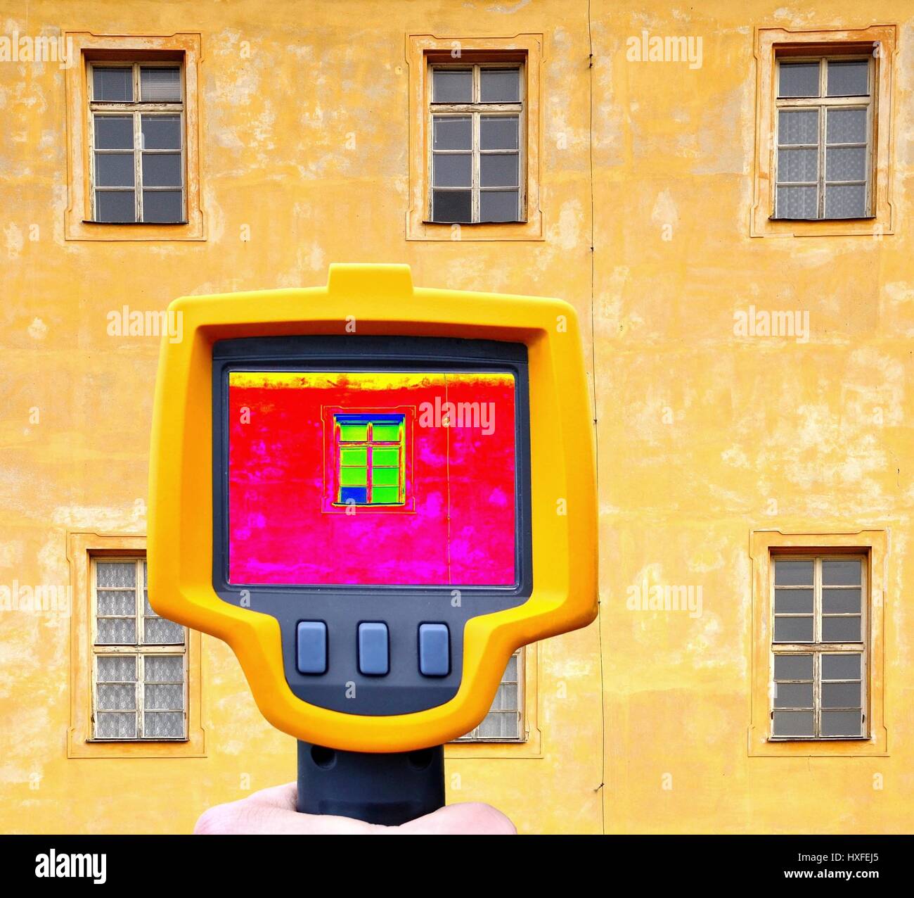 An infrared thermal imager showing building facade and window heat loss. Stock Photo