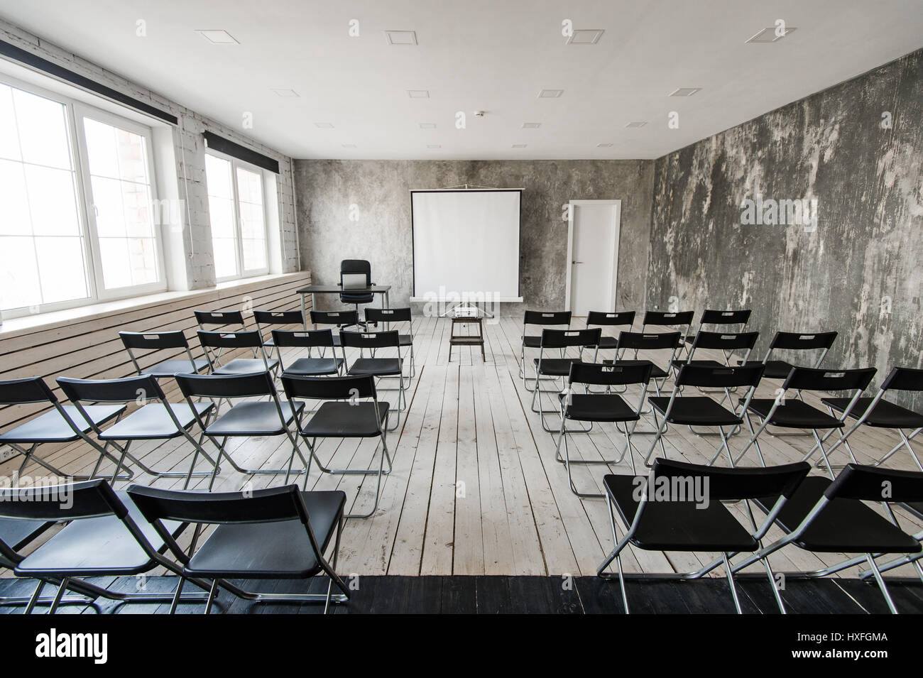 Empty modern classroom with black chairs projector screen Stock Photo