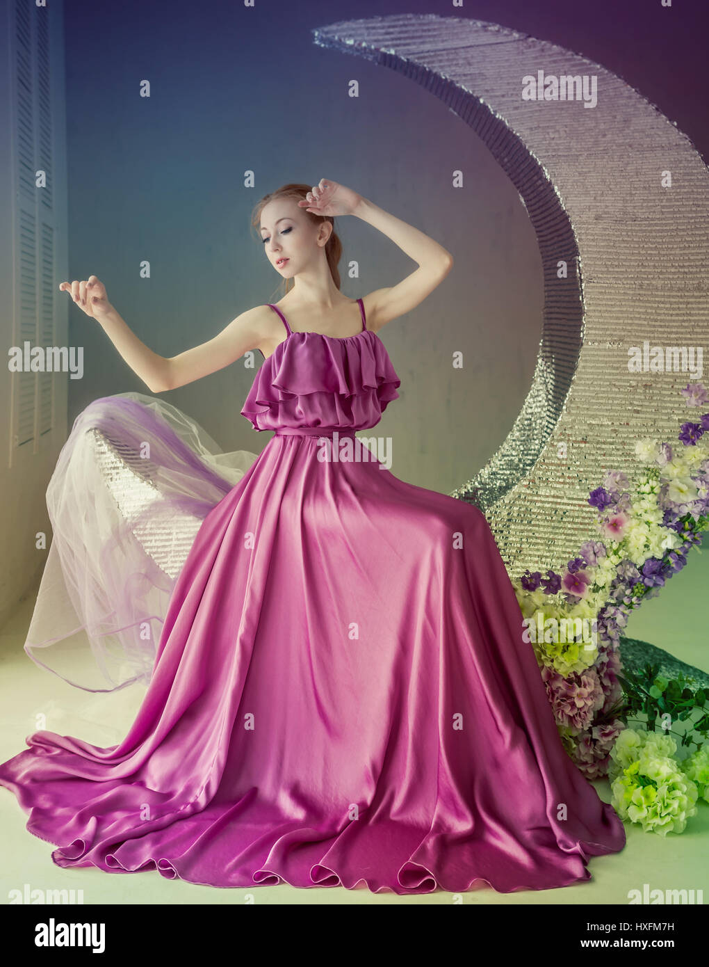 Cute girl dancer in a beautiful dress posing in the studio. Tinted ...