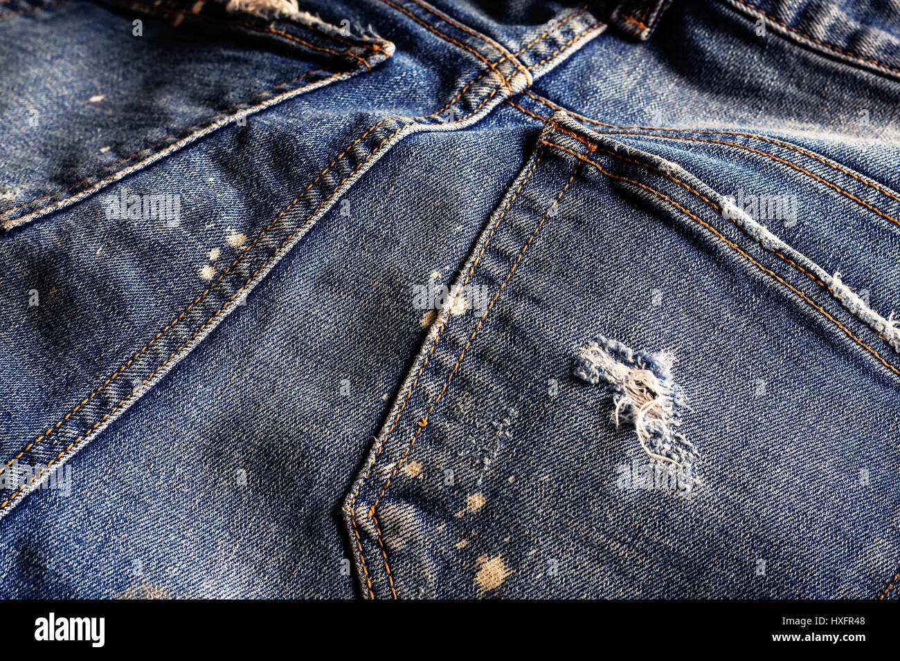 The surface of old jeans and a tear on the fabric Stock Photo - Alamy