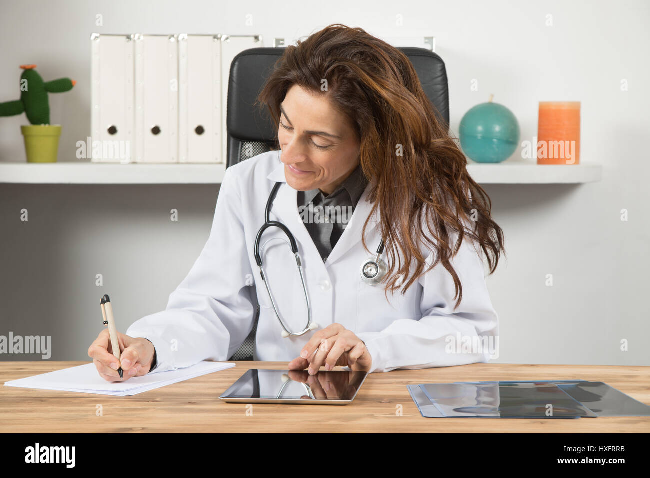 Жену врач видео. Доктор за рабочим столом. Женщина врач на столе. Женщина врач в кабинете. Врач за письменным столе.