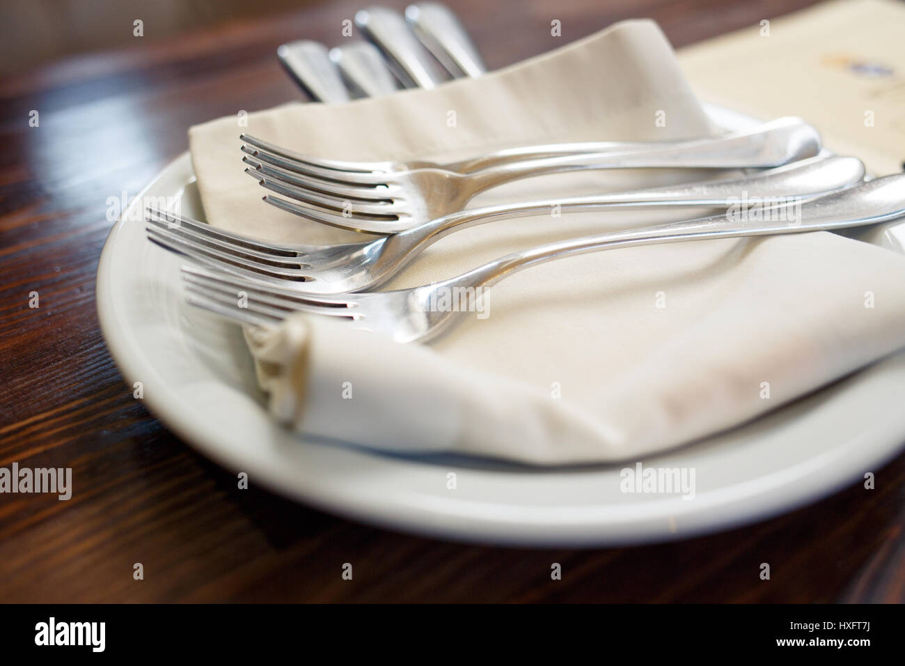 Close up image of forks and knives served on the table in restaurant. Cutlery background Stock Photo