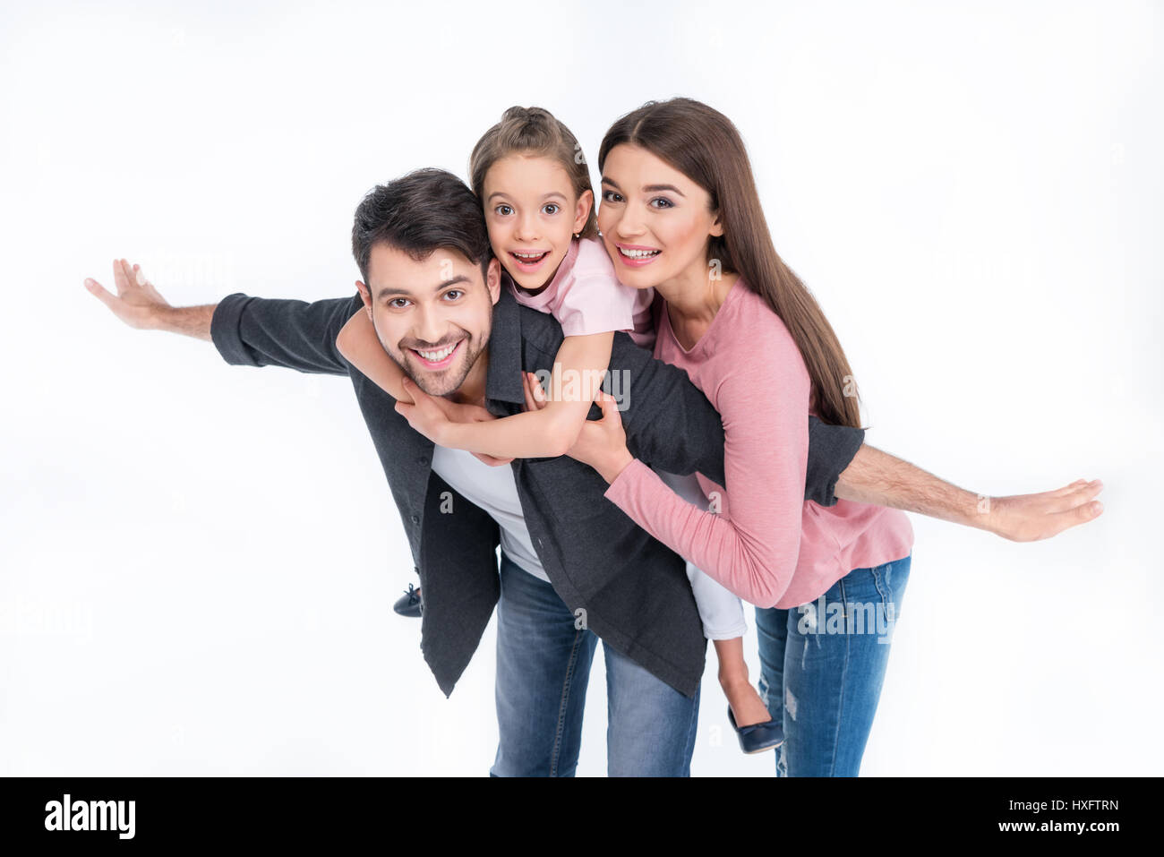 Happy young family with one child having fun together on white Stock Photo