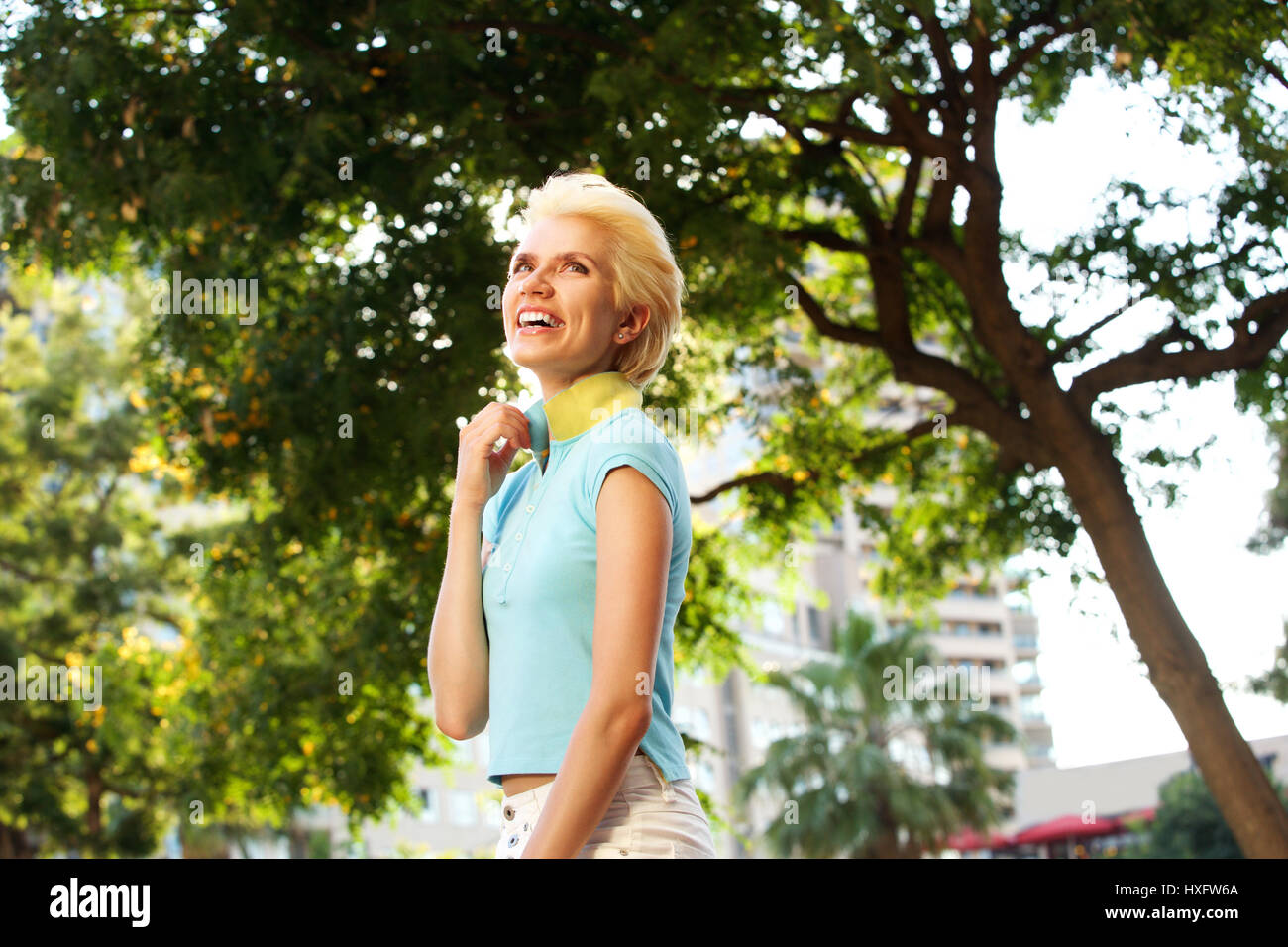 Portrait of a cheerful young woman smiling outdoors Stock Photo - Alamy