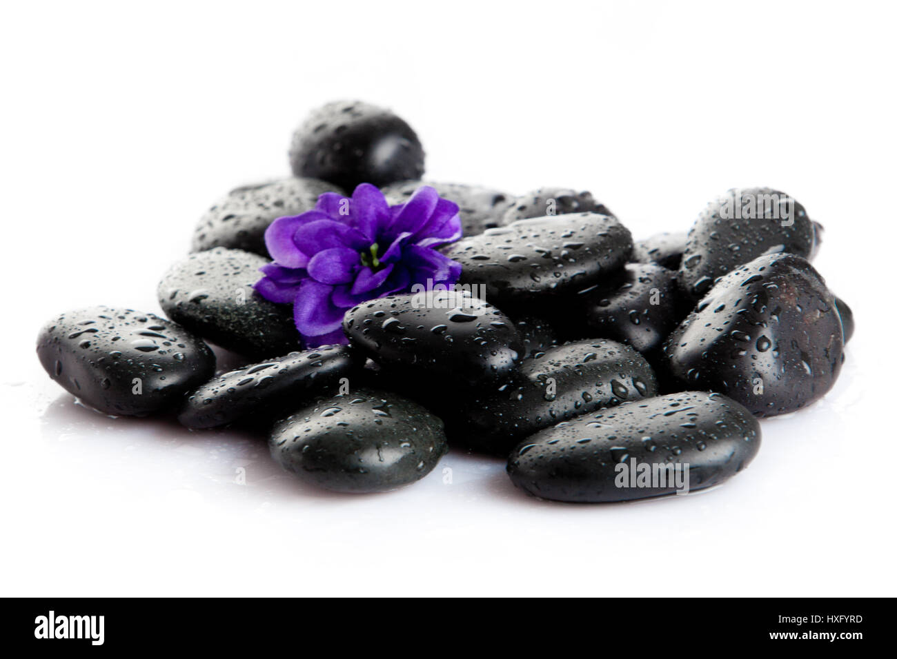 Spa stones with drops and flowers isolated on white Stock Photo - Alamy