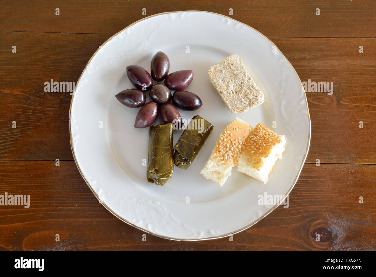 Fasting food concept of plate with olives, dolma, sunflower halva and