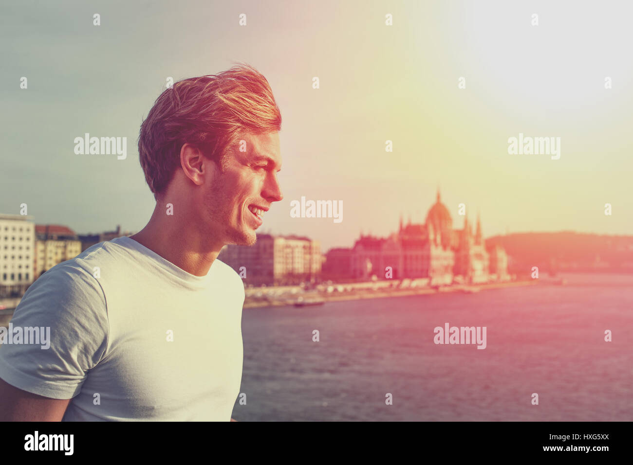 Young man looking away in sunset at Budapest, Hungary Stock Photo