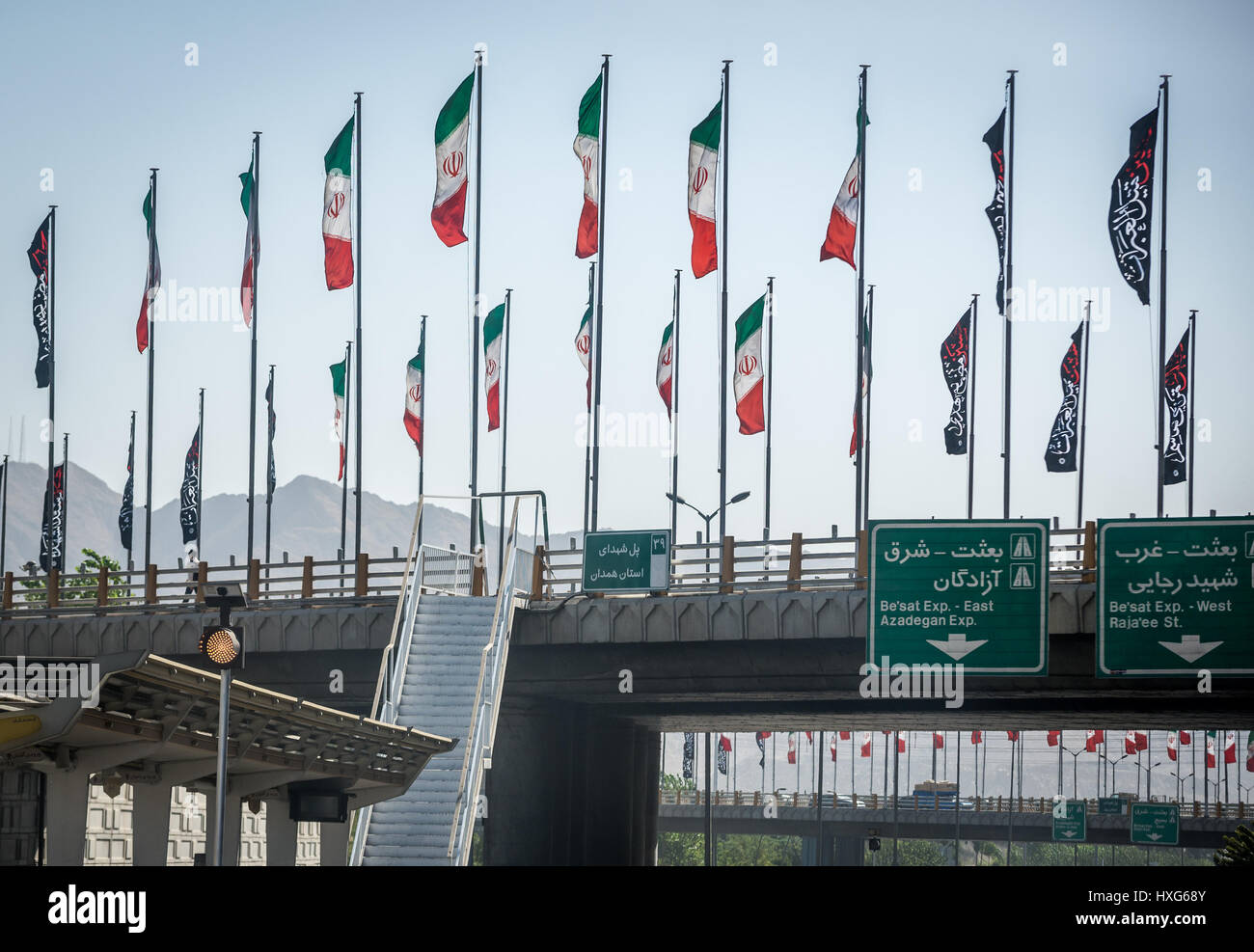 Iranian flags on a road above higway in Tehran city, capital of Iran and Tehran Province Stock Photo