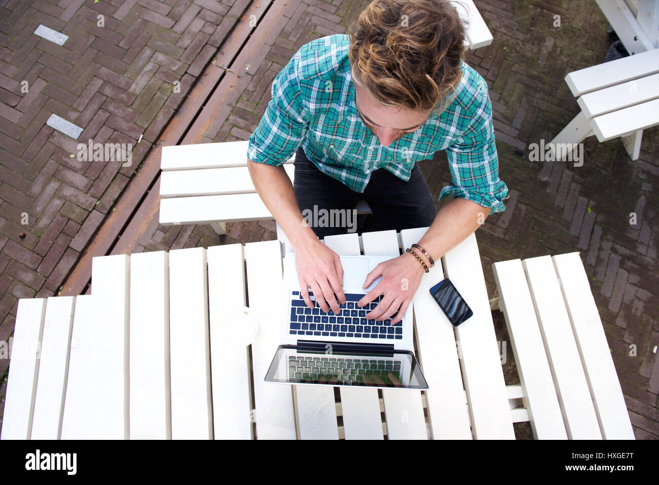 Top view man working with laptop outside Stock Photo - Alamy