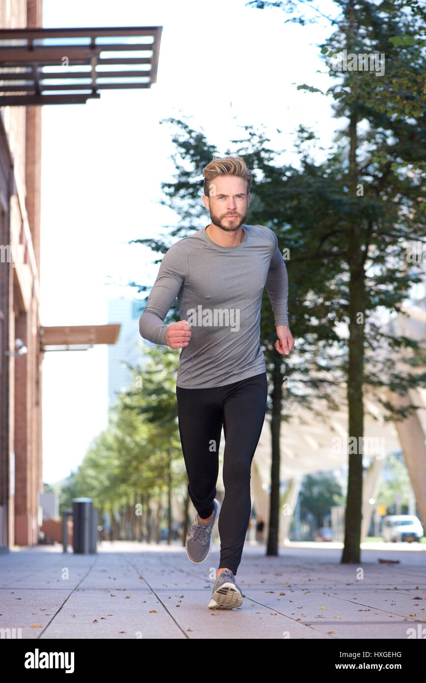 Running Portrait Full length portrait man running in the city Stock Photo - Alamy