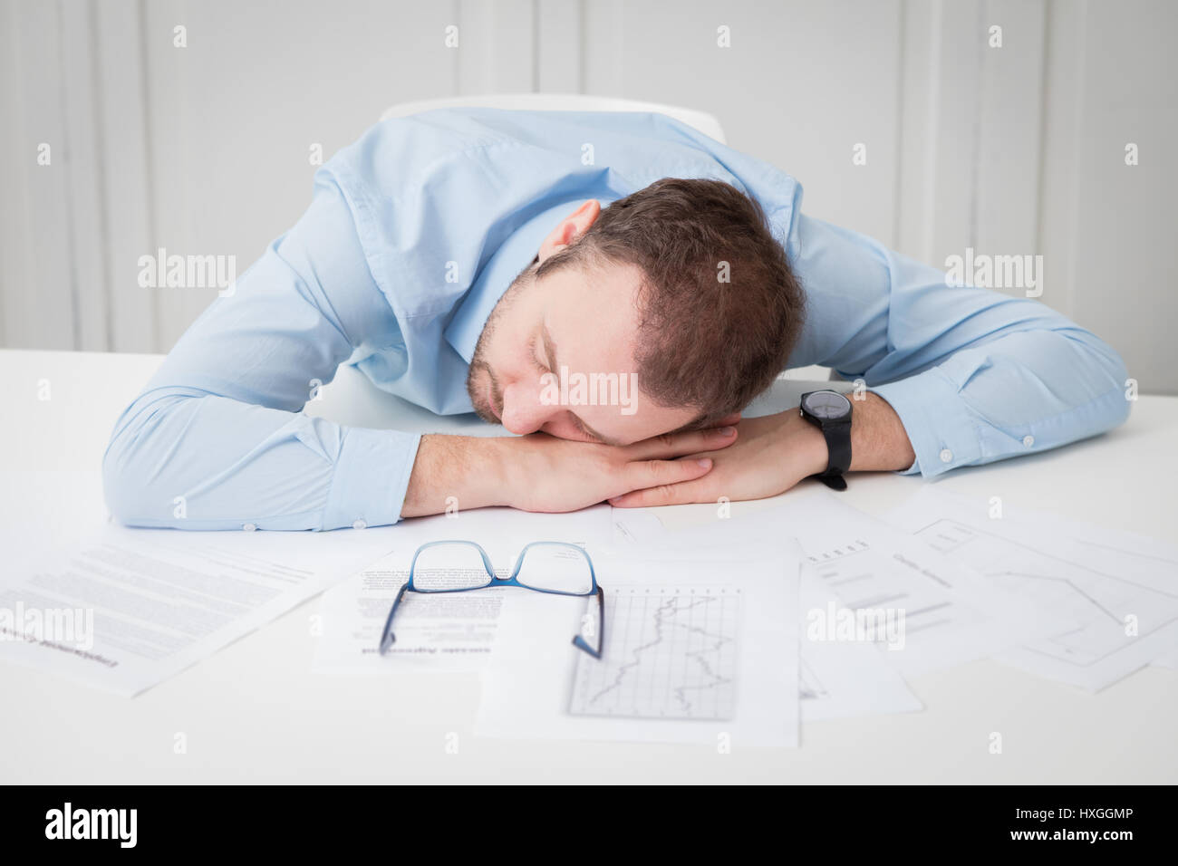 Tired businessman sleeping at the office desk Stock Photo