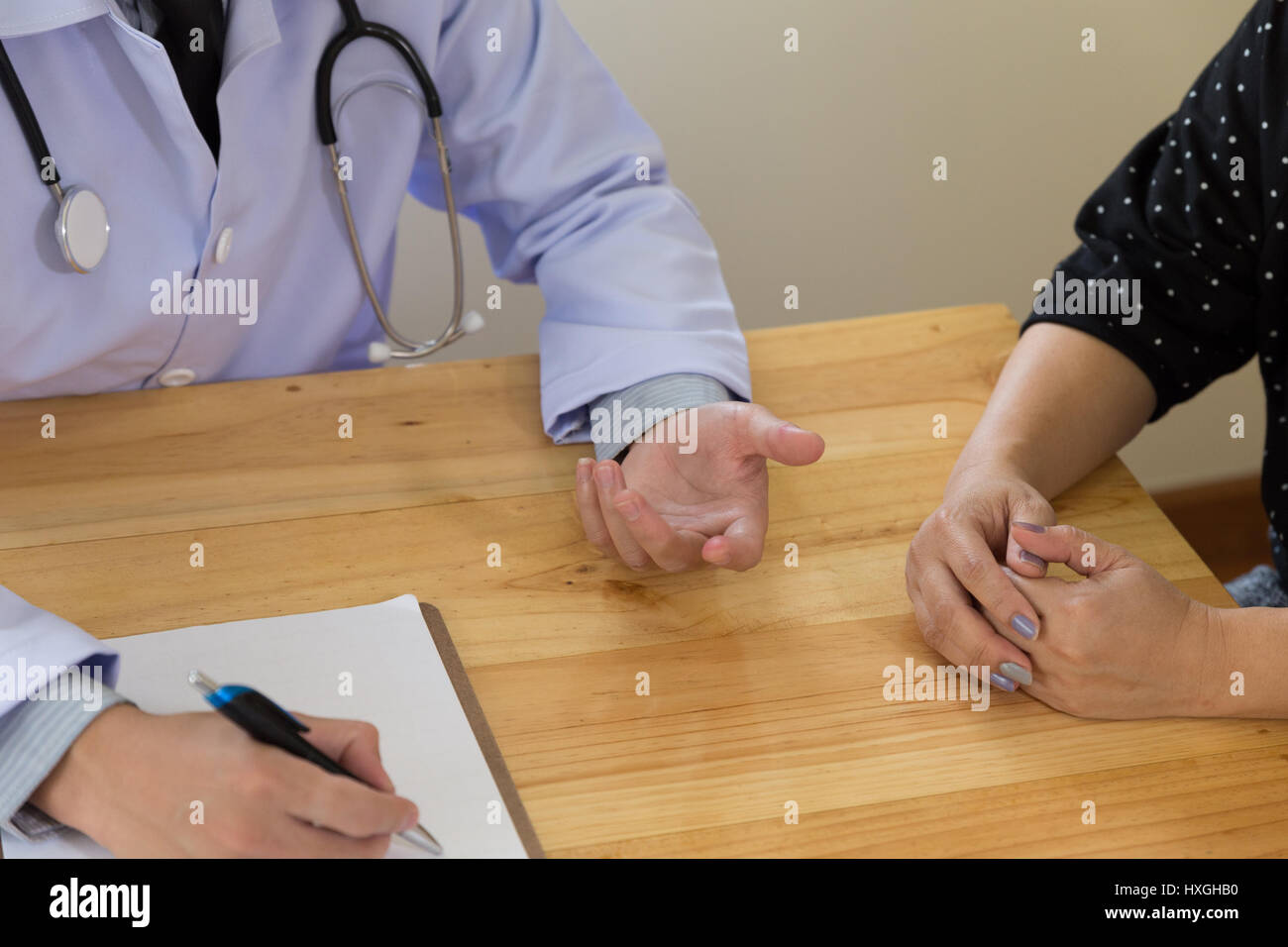 Professional medical doctor in white uniform gown coat consulting ...
