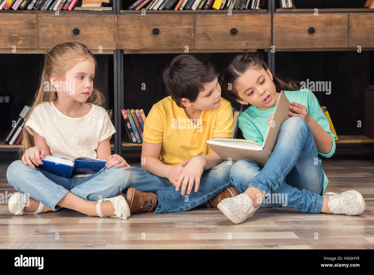 boy and girls reading books in library Stock Photo - Alamy